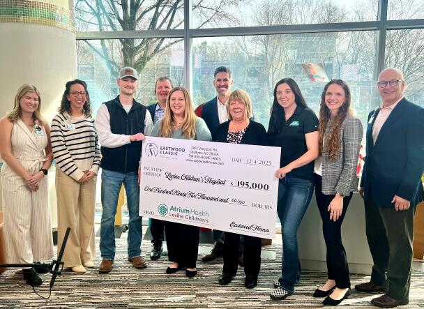 Eastwood team members holding charity check for Levine Children's Hospital