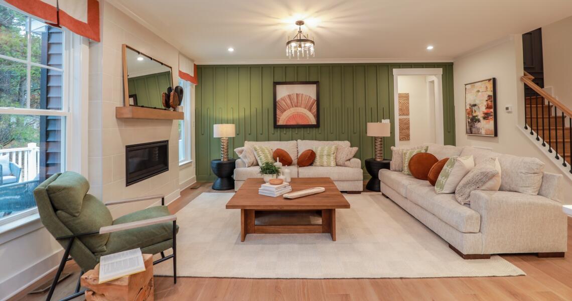 Living area green accent wall with trim