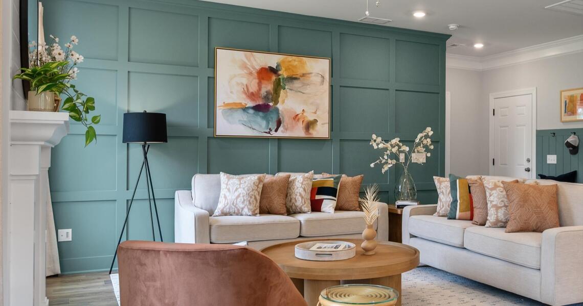 Teal accent wall with trim in living room