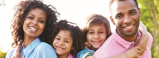 African American family of four smiling